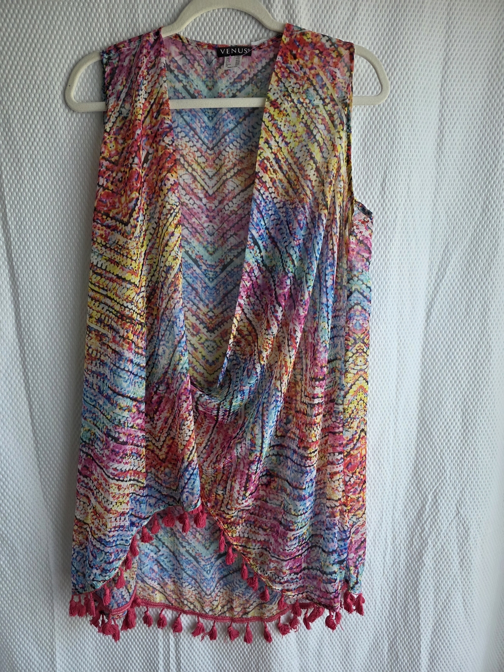 The lightweight Venus cover-up is adorned with a vibrant geometric pattern